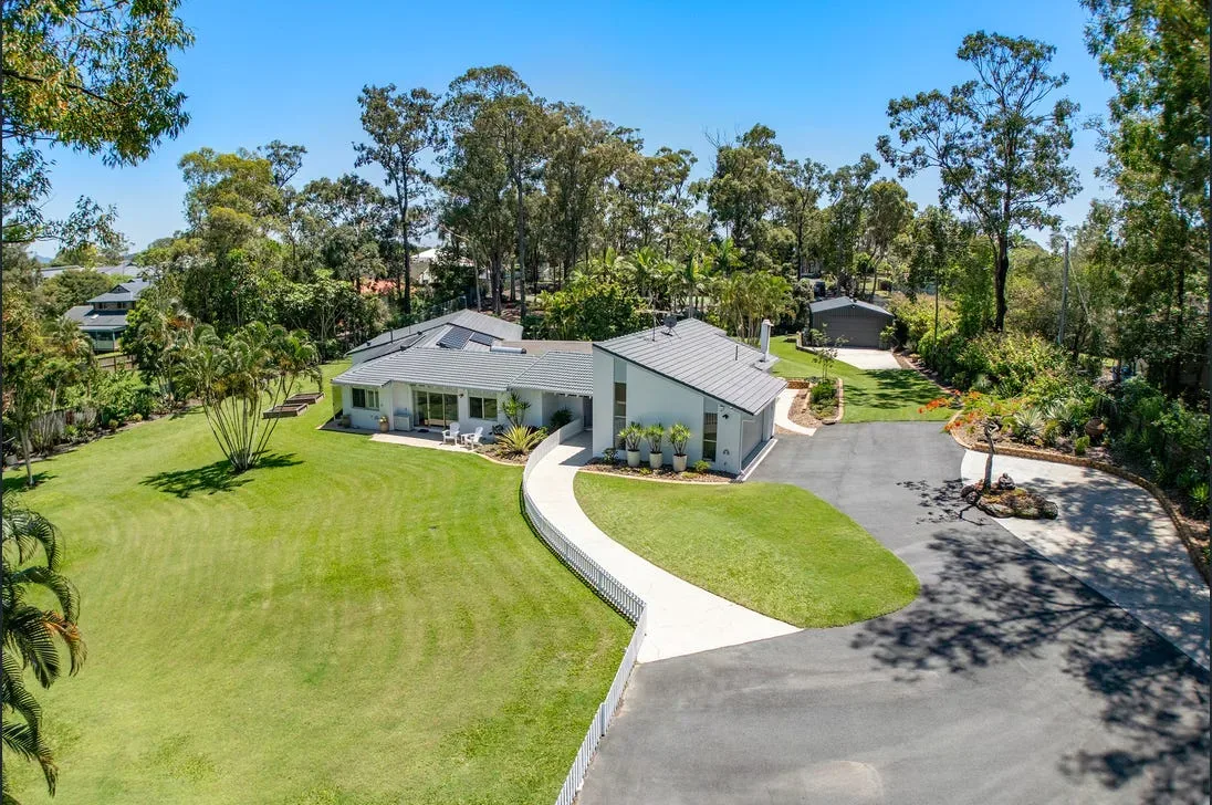 Concrete driveway leading to a modern home